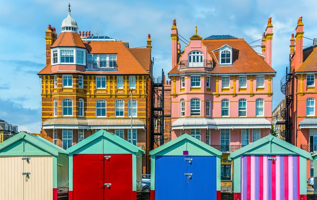 Brightly coloured beach huts on the promenade in Hove Sussex